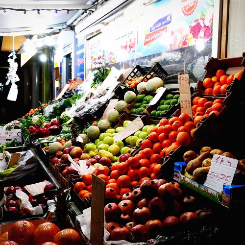 Colorful fresh produce market stall with fruit and vegetables, Arabic signage, Berlin