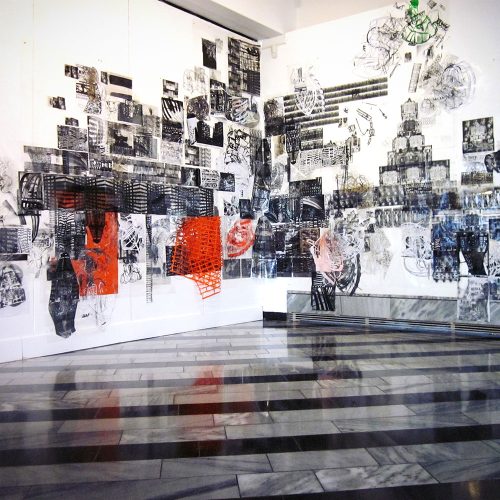 Large-scale mixed-media wall installation with collaged photographs, architectural drawings, and red sculptural elements, Berlin gallery