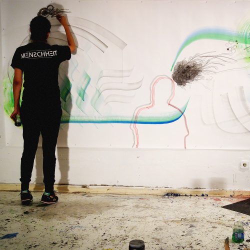 Artist working on mural with flowing abstract lines and organic shapes in studio space, Berlin Neukölln